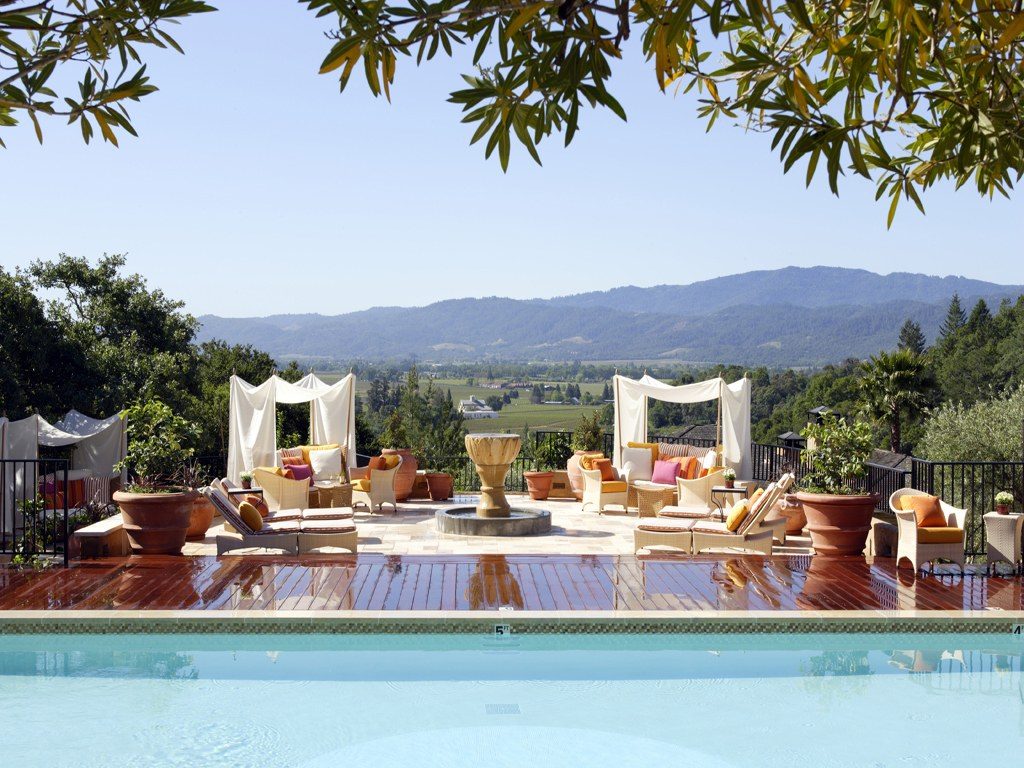 Photo of the outdoor setting and pool at Auberge Du Soleil in the Napa Valley, California overlooking a mountain range