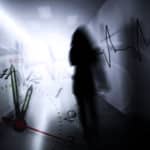 A dark outline of a woman walking in a light hallway with overlaid images of a clock face and a heart monitor